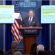 Sean Spicer holds up offensive tweet.